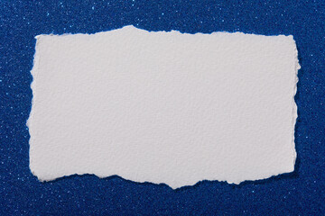 Torn paper on blue sparkle background