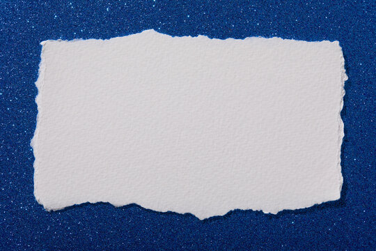 Torn paper on blue sparkle background
