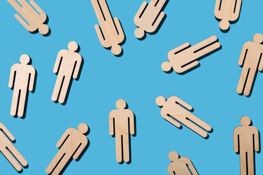 Wooden cutouts of people on blue background