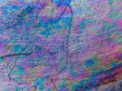 Close-up view of scratched and oxidized stainless steel pan