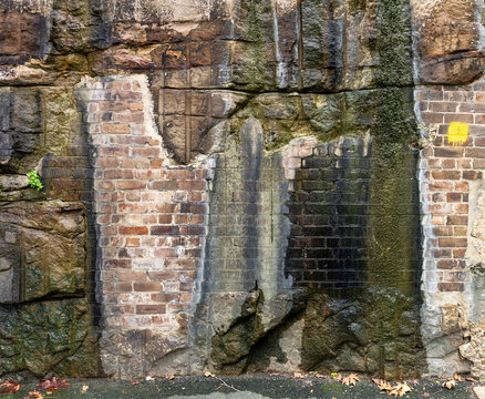 Mixed material wall with water seeping down