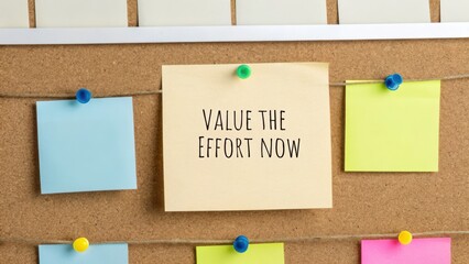 Sticky Note with Value the Effort Now on Cork Board
