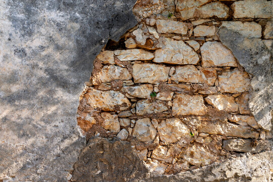 Close-up of limestone wall with crumbling plaster