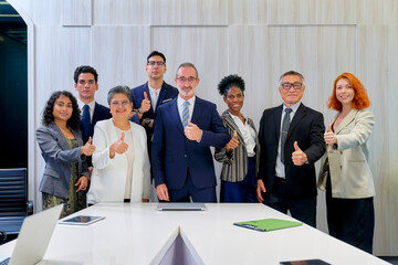 Group of diverse business team trumb up for take a photo to confirm quality of business service in meeting room of office.