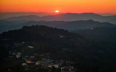 A mountain range with a sunset in the background Doi maesalong, Chiang rai,thailand