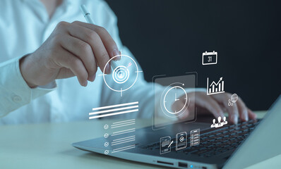 business professional using digital tools on laptop to manage goals, time, productivity, showcasing modern technology, data-driven planning, efficient workflow in today’s smart work environment.