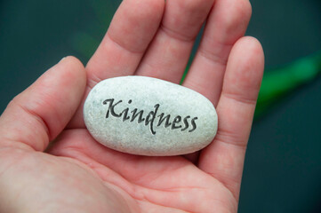 Graciousness text engraved on the stone hold by han