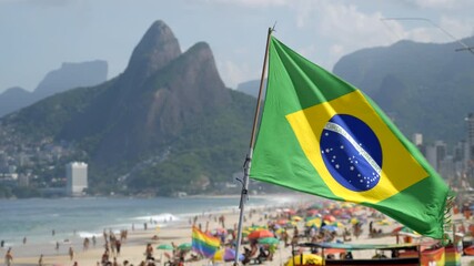 Brazilian flag waving in the wind with Ipanema Beach in the background, Rio de Janeiro, Brazil. - Powered by Adobe