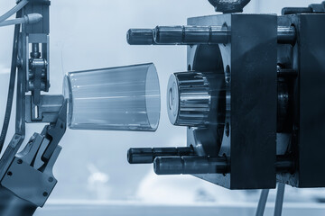 The plastic parts production process from injection mold machine in the light blue scene.