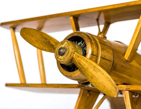 Wooden model airplane featuring intricate propeller design, showcasing craftsmanship and vintage aviation history at close range