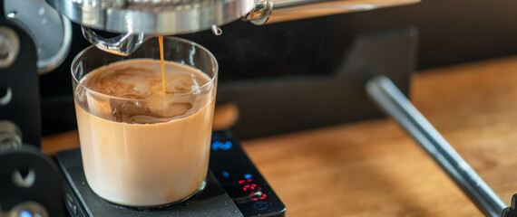 Coffee Machine Detail: Close Up of Portafilter and Glass Cup during Espresso Process Rich Espresso: Dark Coffee Dripping with Crema into Transparent Glass Specialty Dark Coffee Flowing into Glass Cup.