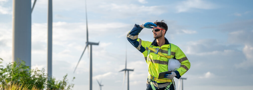 man visionary engineer looking ahead wind inspector looking forward inspection check control wind power machine out door wind energy factory.technician professional worker check wind power turbine