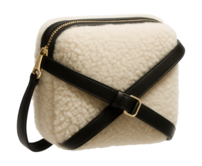Shearling crossbody bag featuring a contrasting strap and zippered closure.