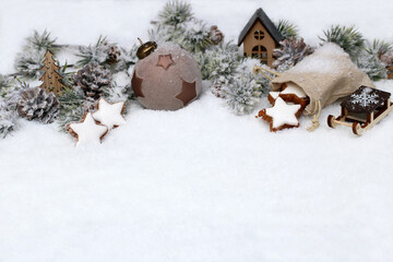 Christmas background: Winter landscape with Christmas decorations and fir branches in the snow.