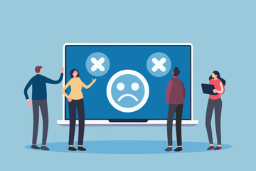 Diverse team members react to negative feedback and a sad face on a large computer screen