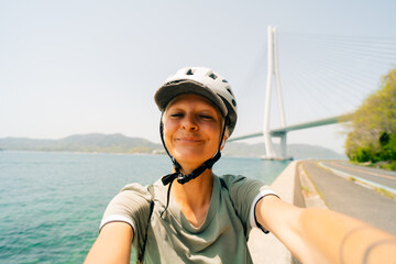 shikoku, japan - 3 august 2025 Female cyclist on Shimanami kaido cycling route