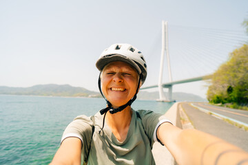 shikoku, japan - 3 august 2025 Female cyclist on Shimanami kaido cycling route