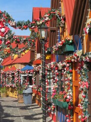 festive colorful Christmas decorations in a European style town  with garlands, lanterns