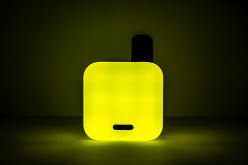 Futuristic Vibes, Yellow Neon Electronic Cigarette in the Dark