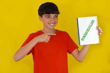 homeschooling concept. Teenager pointing to the word written in a notebook.
