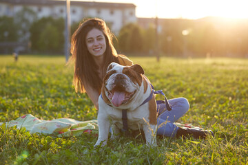 Young brunette girl play with her british bulldog