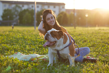 Young brunette girl play with her british bulldog