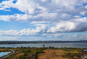 Picturesque natural and industrial landscape under wonderful cumulus clouds