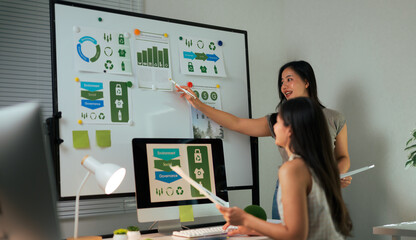 Businesswomen discussing ESG strategy with data analysis