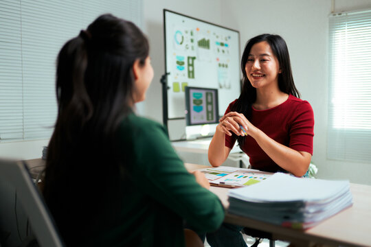 Business women discussing data analysis during meeting
