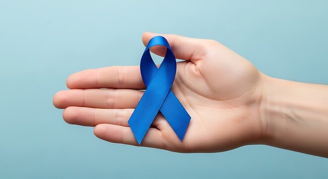 Symbol of hope Hand holding a blue awareness ribbon for men's health