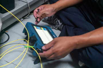 Technician Testing Fiber Optic Network Cable