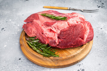 A selection of fresh beef shin, boneless shank meat cuts on a butcher block, emphasizing their quality and versatility for various cooking methods. greybackground. top view