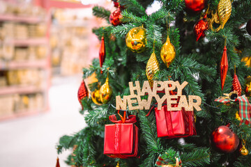 A festive Christmas tree decorated with colorful ornaments, shiny baubles, gift boxes, and holiday ribbons, creating a warm seasonal atmosphere perfect for celebration themes and winter holiday design