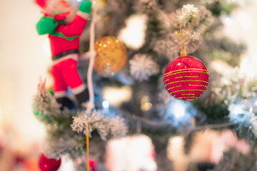 Closeup snowy Christmas tree decoration,red,gold,silver ornament with bokeh background. Perfect holiday sales, winter celebration, festive seasonal promotions, marketing, shopping with copy space