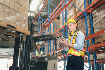 Smart caucasian warehouse man,manager use digital tablet check package with worker forklift driver loading box on shelf, product distribution inventory management, Logistics shipping business planning