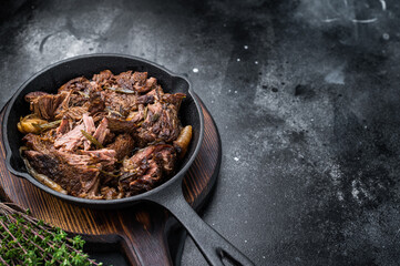 Beef bourguignon stew with tender beef in a pan. black background. top view