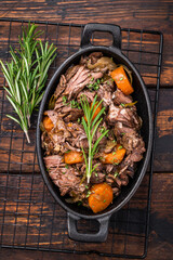 Skillet of beef bourguignon with tender beef, carrots, and mushrooms. wooden background. top view