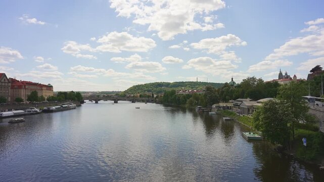 Scenic Vltava River view with Petrin Hill.