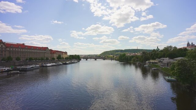 Scenic Vltava River view with Petrin Hill.