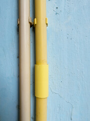 PVC electrical conduit pipes attached on house wall for wiring installation.