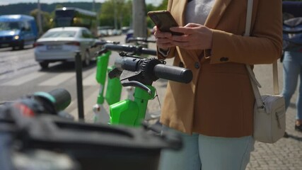 Woman tourist rents electric scooter by phone.