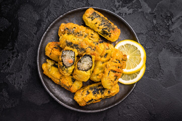 Gimmari or Kimmari, Korean seaweed rolls filled with vermicelli. black background. top view