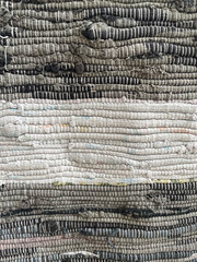 Close-up of a handwoven textured fabric with layered neutral tones. Detailed textile pattern ideal for backgrounds, DIY crafts, interior design, and material concepts. High-resolution macro shot.