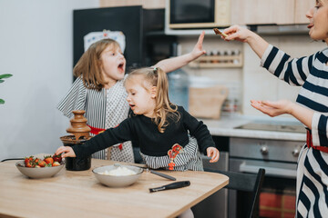 Young children and an adult savor chocolate fondue with strawberries in a home kitchen. The image captures joyful and culinary moments, emphasizing the connection of family and the joy of desserts.