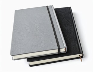 Stacked grey & black notebooks, bound, on white