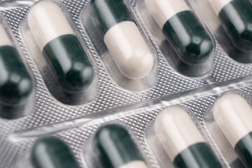 Pile of tablets pill in silver blister packaging background. Aluminium foil blister pack. Pharmacy...