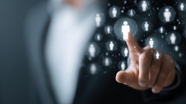 Business professional touching digital icons representing human resources and networking connections in a modern corporate environment
