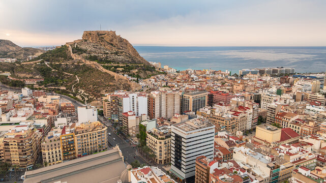 Alicante after sunset. Coastal areas with modern buildings, sea, mountains. Spain. Tourists' choice.