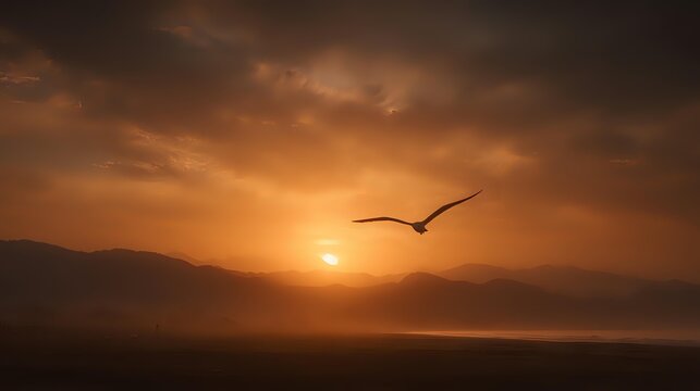 Dramatic silhouette of bird soaring against golden sunset sky with mountain landscape and atmospheric mist, creating serene wilderness mood. - Powered by Adobe