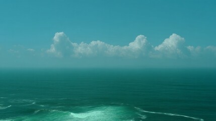 Fototapeta premium The sky is blue and the ocean is calm. The clouds are white and scattered